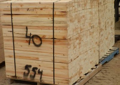 large stacks of custom cut lumber on wooden pallets