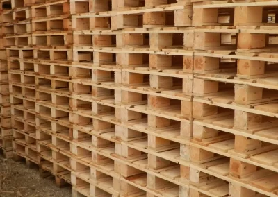Many 4-way wooden pallets stacked on top of each other. The stacks fill the entire image.
